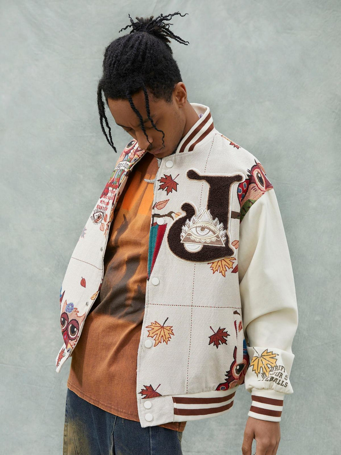 Model in a TALISHKO embroidered baseball jersey, featuring owl patches and autumn leaves.