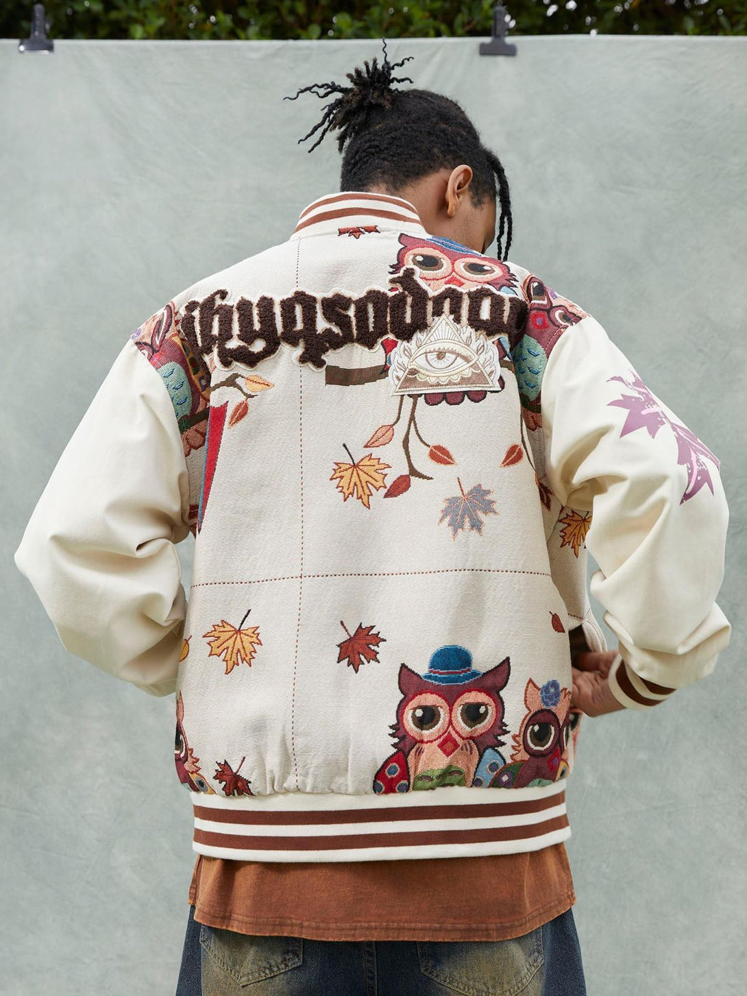 Back view of TALISHKO owl patch baseball jersey, highlighting vibrant embroidery and unique design.