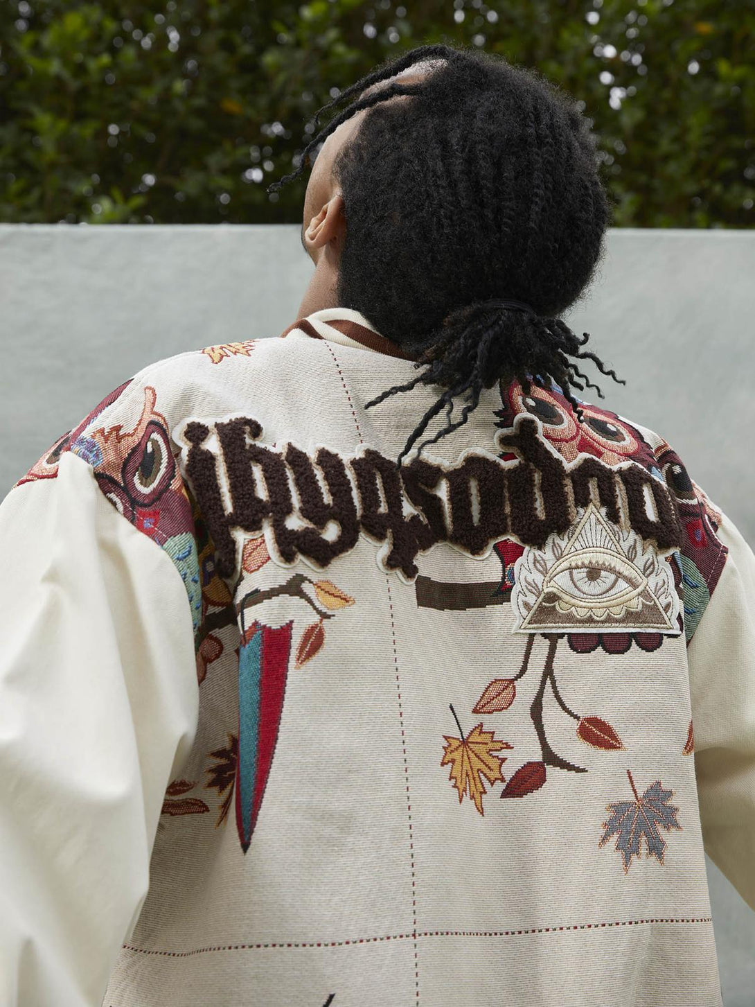 Back view of a TALISHKO embroidered baseball jersey with owl patches and autumn motifs.