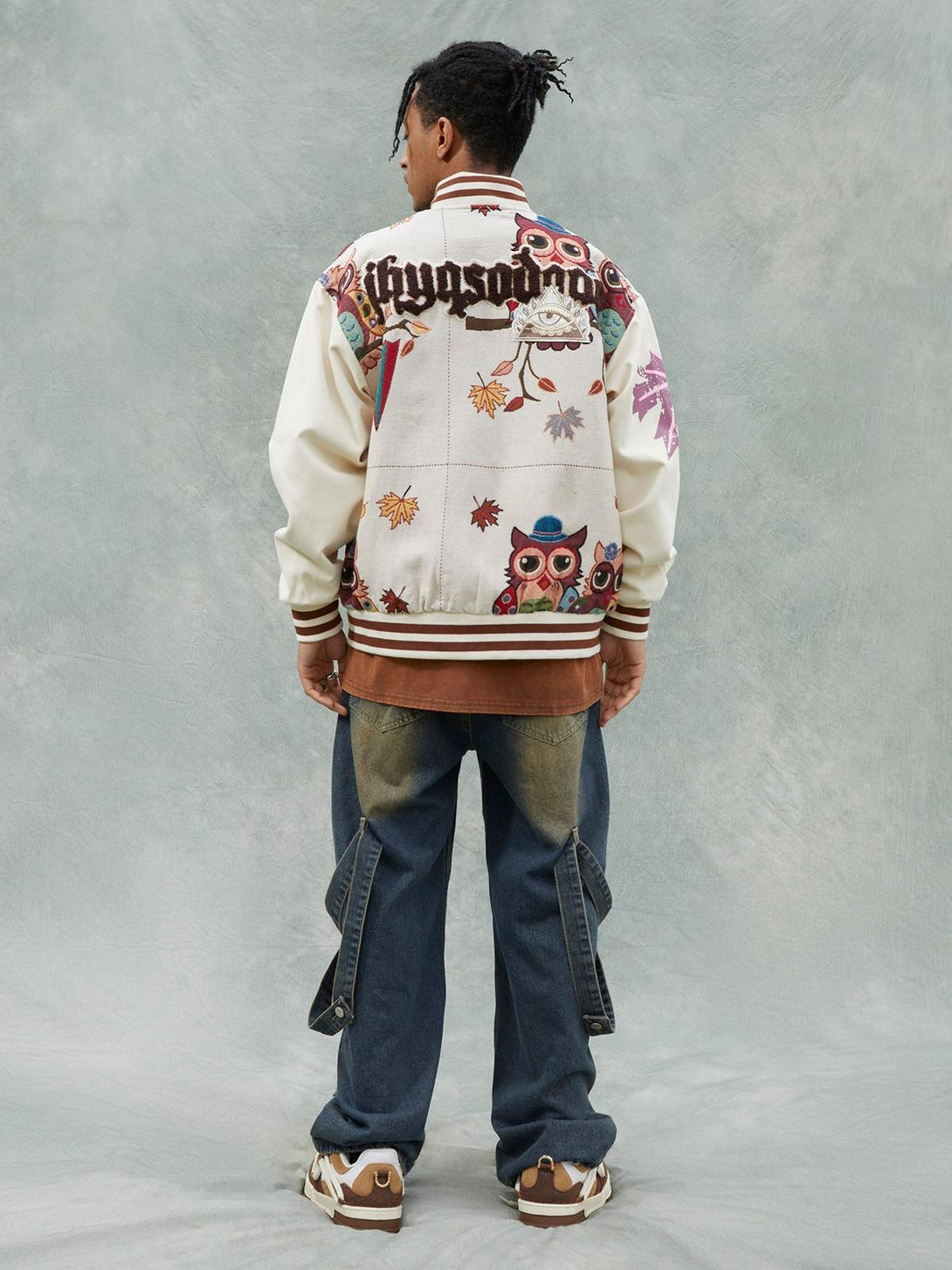 Back view of a TALISHKO owl patch baseball jersey, showcasing vibrant embroidery and casual style.