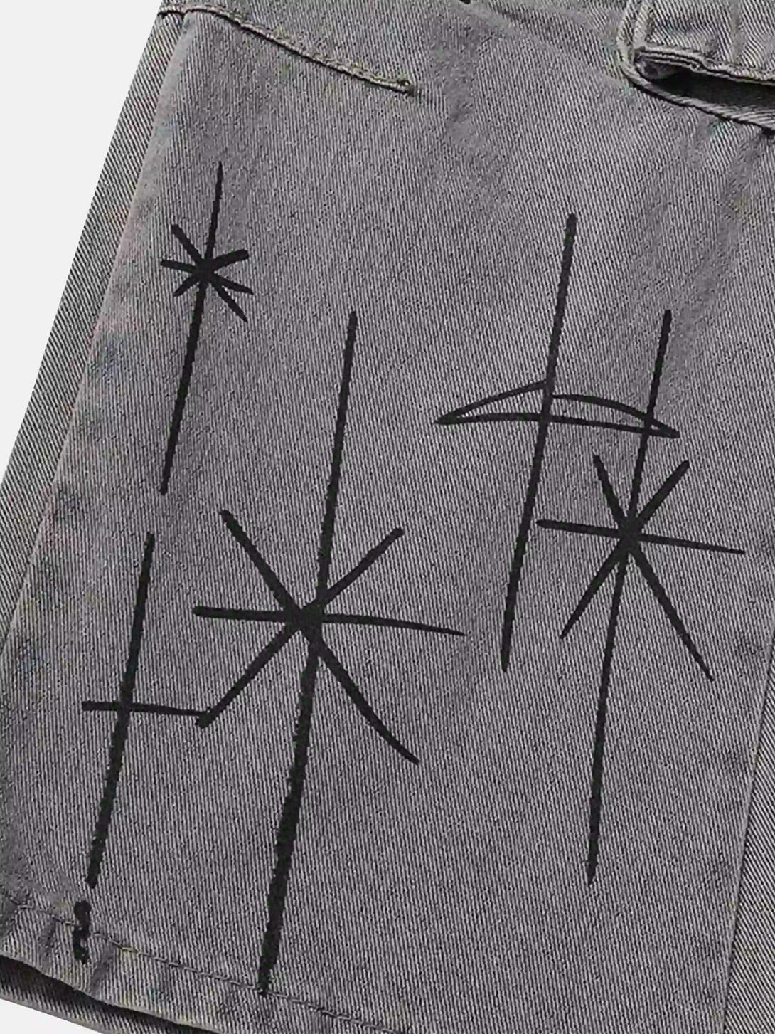 Intricate look at black star patterns on gray TALISHKO cargo jeans, highlighting artistic detail.
