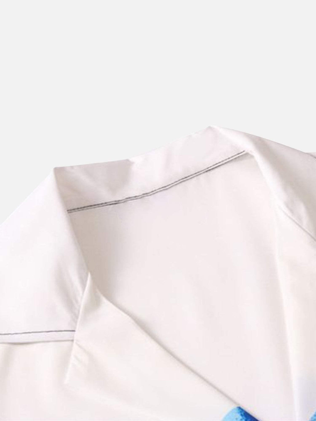 A close-up of TALISHKO's white lapel on a short sleeve shirt, showcasing clean stitching.