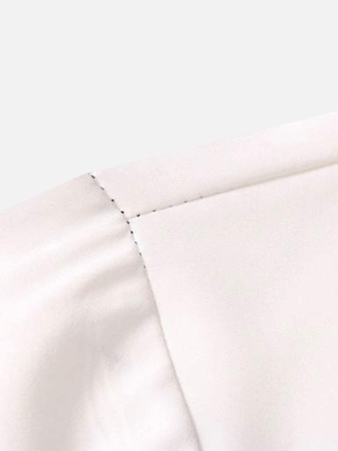 A tight crop highlighting TALISHKO's precise stitching on a white short sleeve shirt collar.