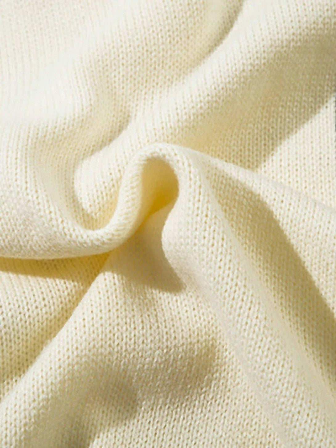 Zoomed-in texture of TALISHKO's palm graffiti cardigan, showcasing its soft knit fabric.