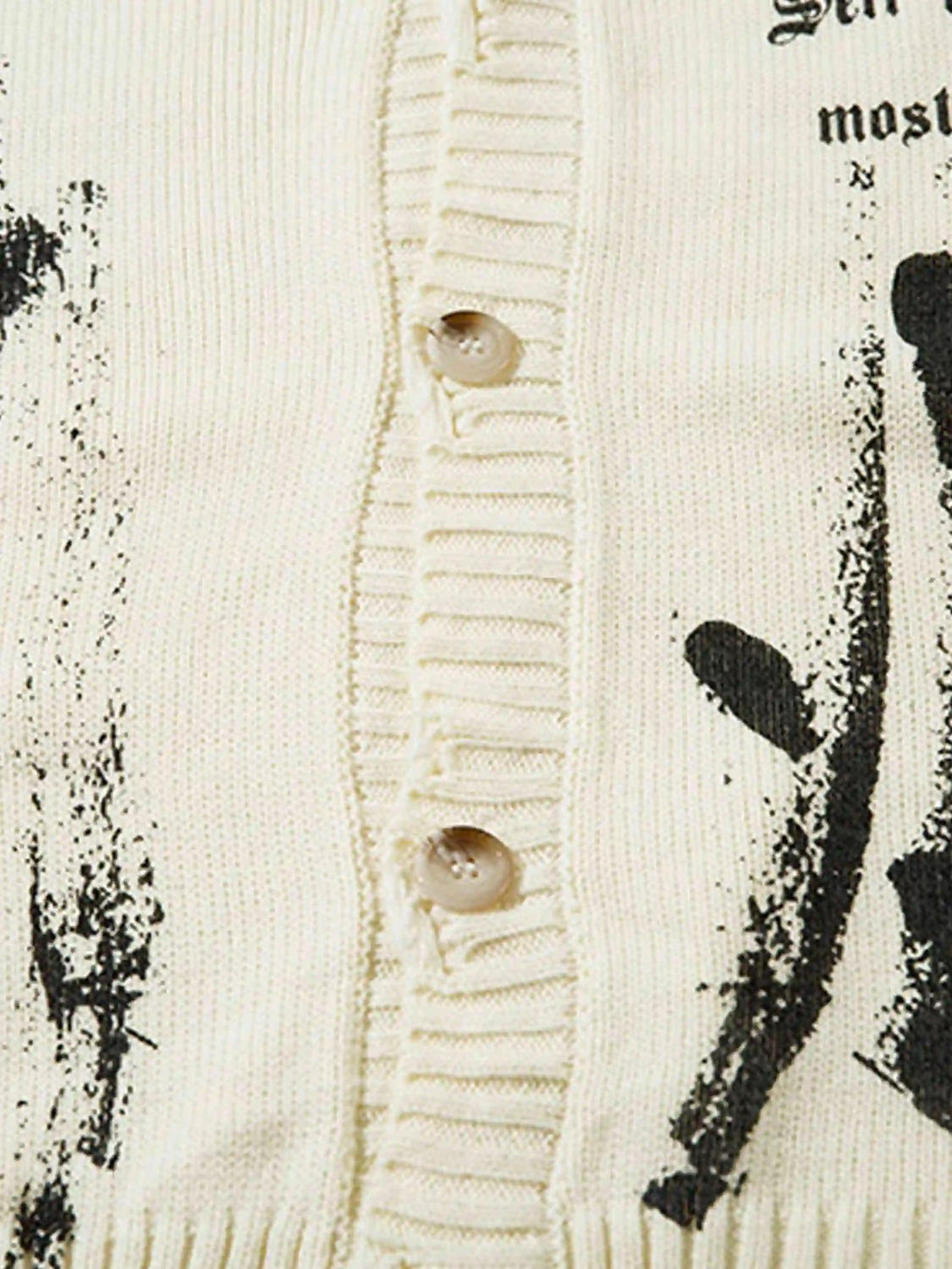 Detailed fabric and button design on TALISHKO's palm graffiti cardigan, highlighting texture.
