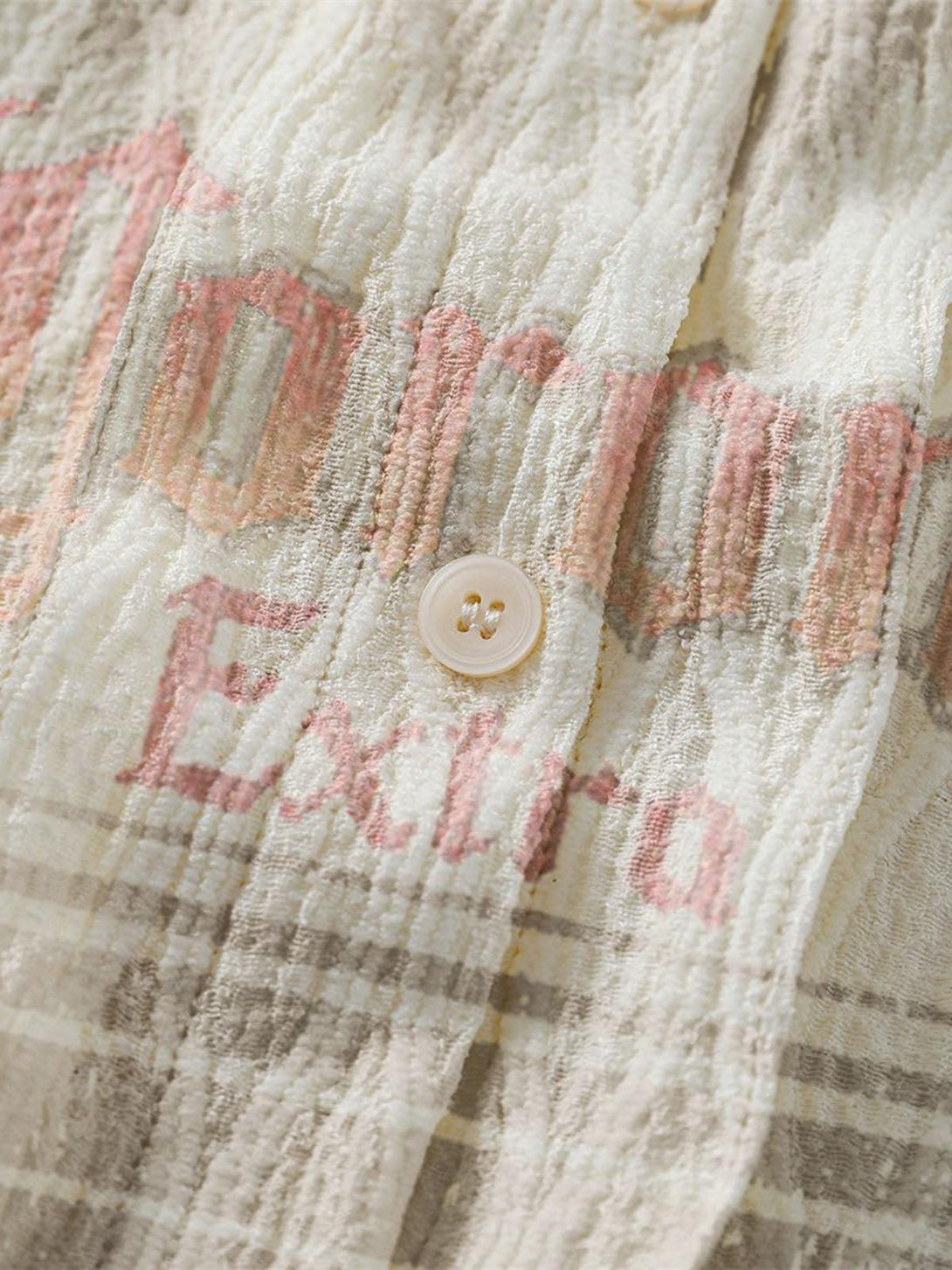 Zoomed-in texture of the palm tree short-sleeve shirt by TALISHKO, highlighting detailed stitching.