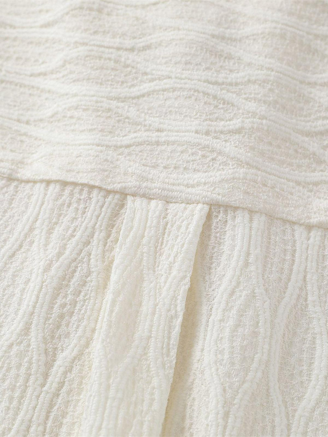 "Detailed fabric and texture of TALISHKO palm tree short-sleeve shirt, showcasing intricate design."