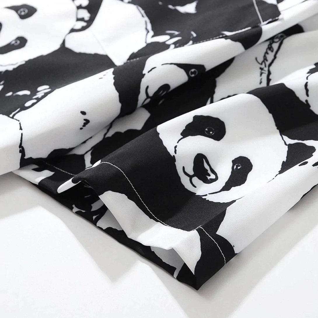 Zoomed-in texture of panda print fabric on a TALISHKO short-sleeved shirt.