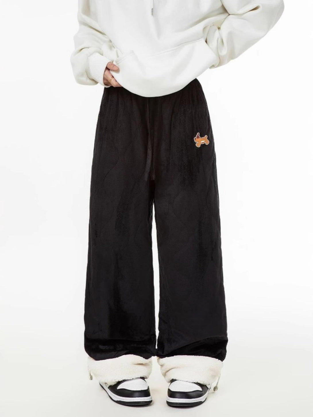 Model wearing black paneled padded sweatpants by TALISHKO, showcasing a cozy, relaxed fit.