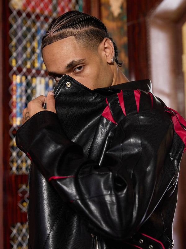 Model wearing TALISHKO paneled spine pleated cropped leather biker jacket, showcasing edgy style.