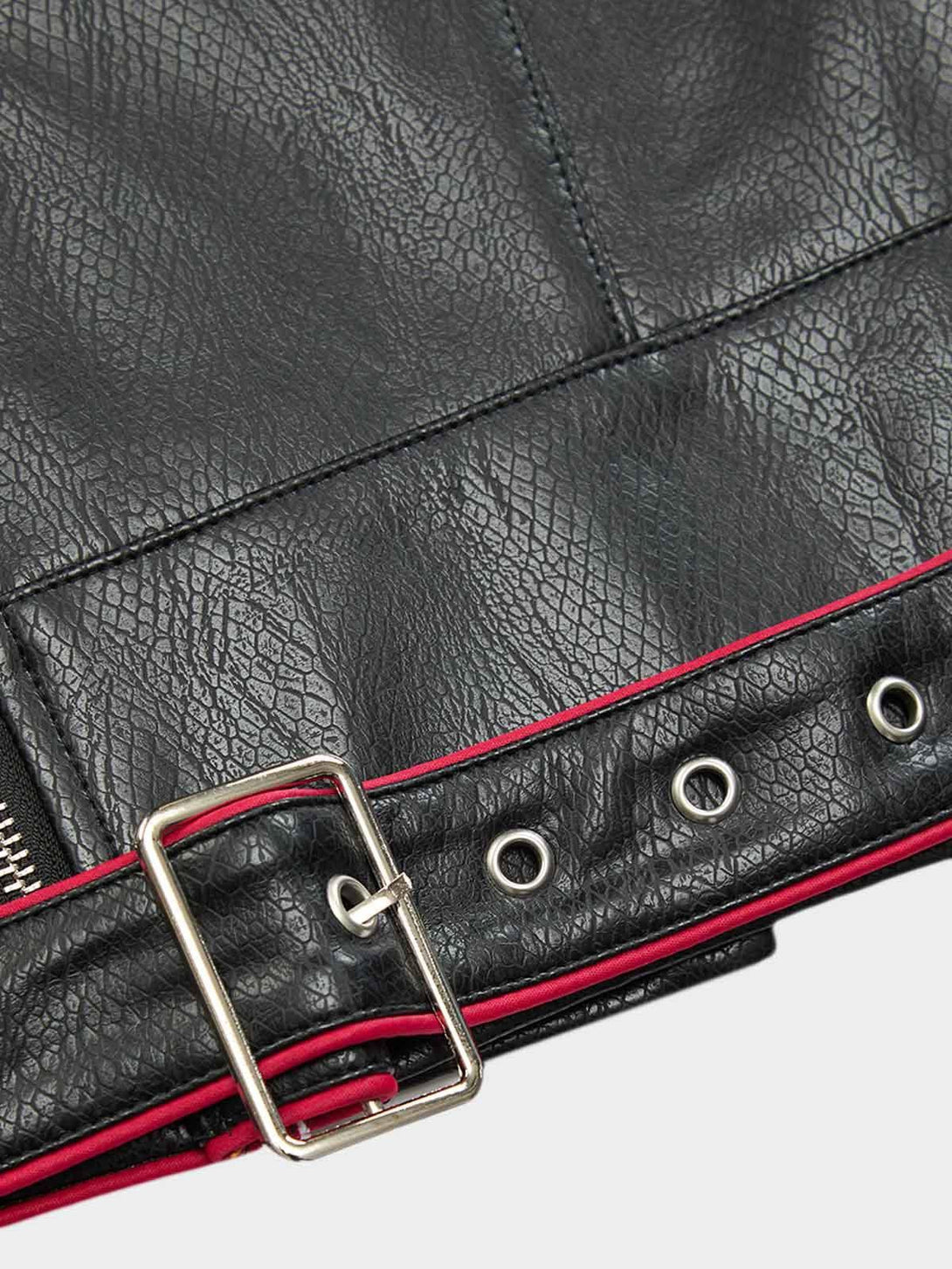 Detailed fabric and buckle design from the TALISHKO biker jacket, featuring red accents.