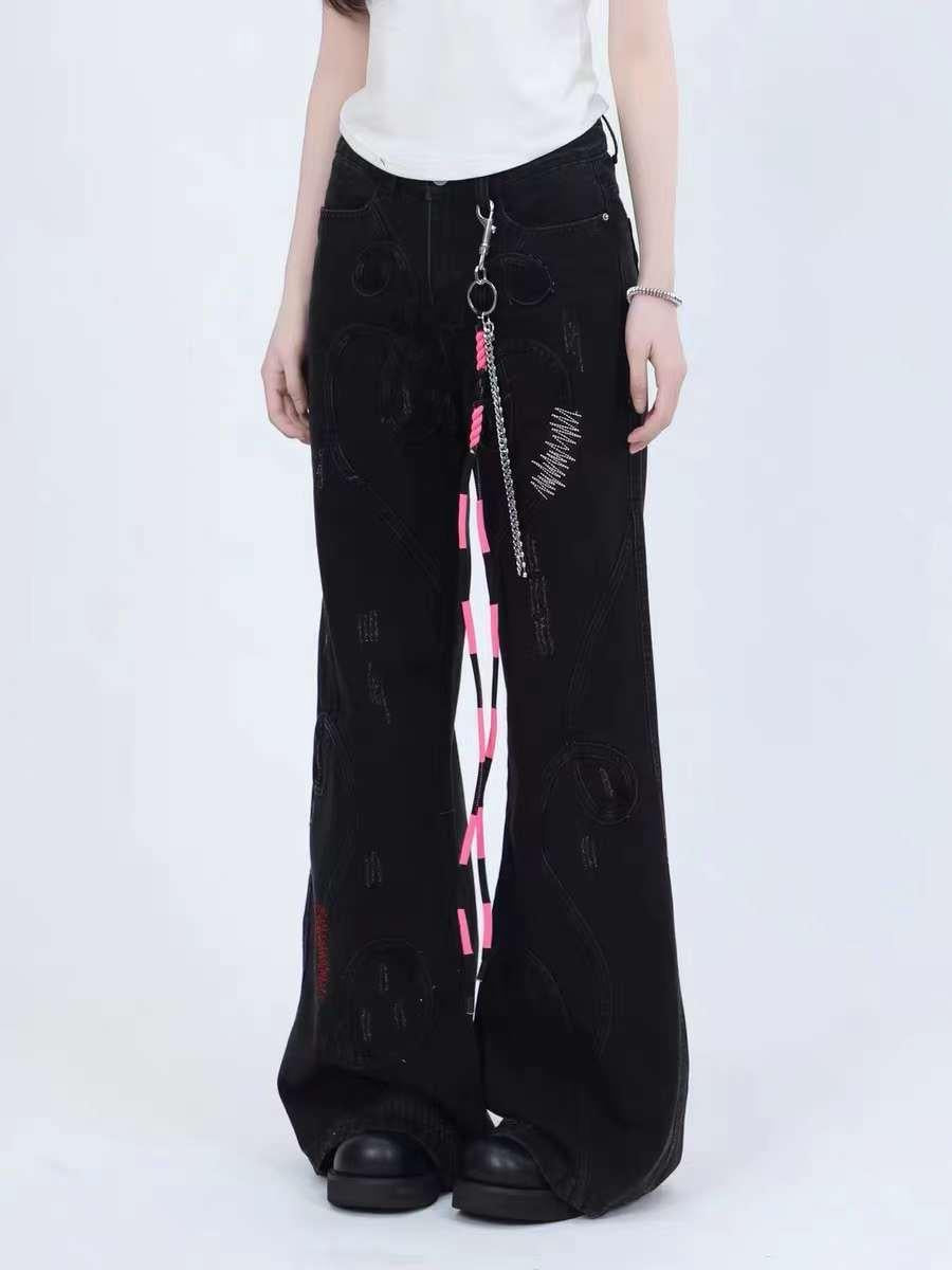 Model in TALISHKO black jeans with a pink-accented chain detail, showcasing a trendy wide-leg fit.