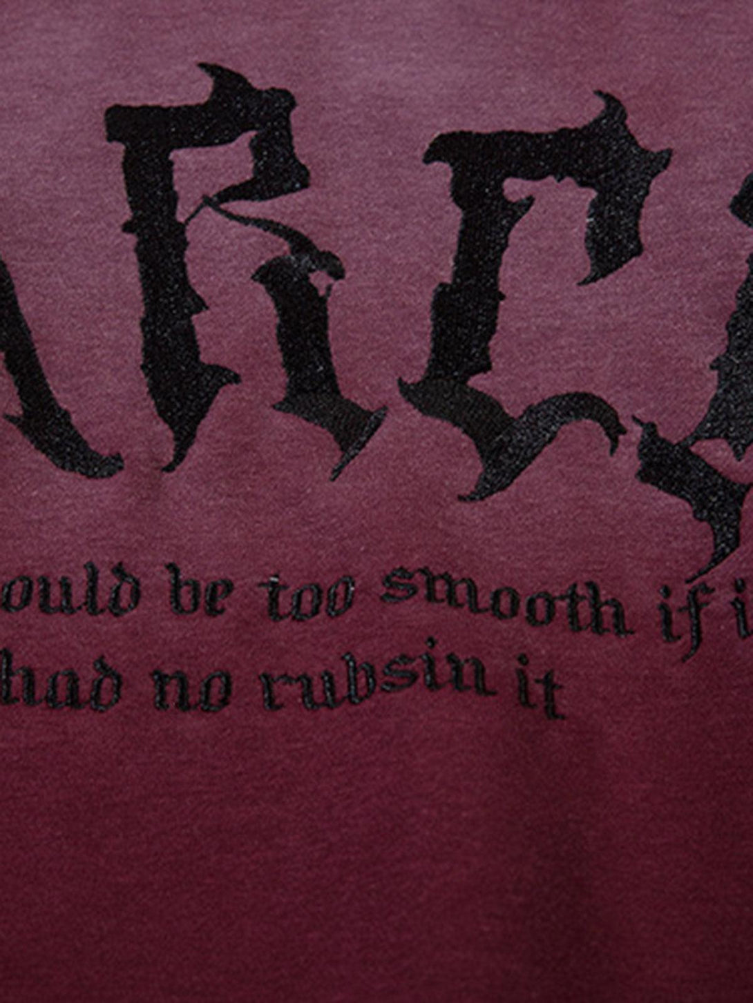 Detailed look at TALISHKO hoodie’s embroidery on gradient fabric, highlighting unique lettering.