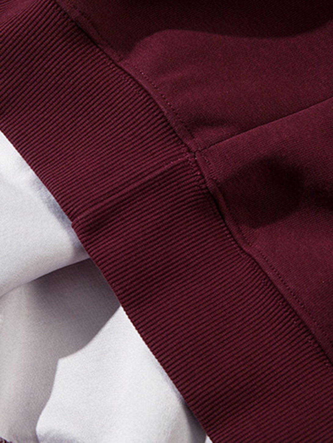 Detailed fabric and stitching of TALISHKO's gradient hoodie, emphasizing its rich burgundy hue.