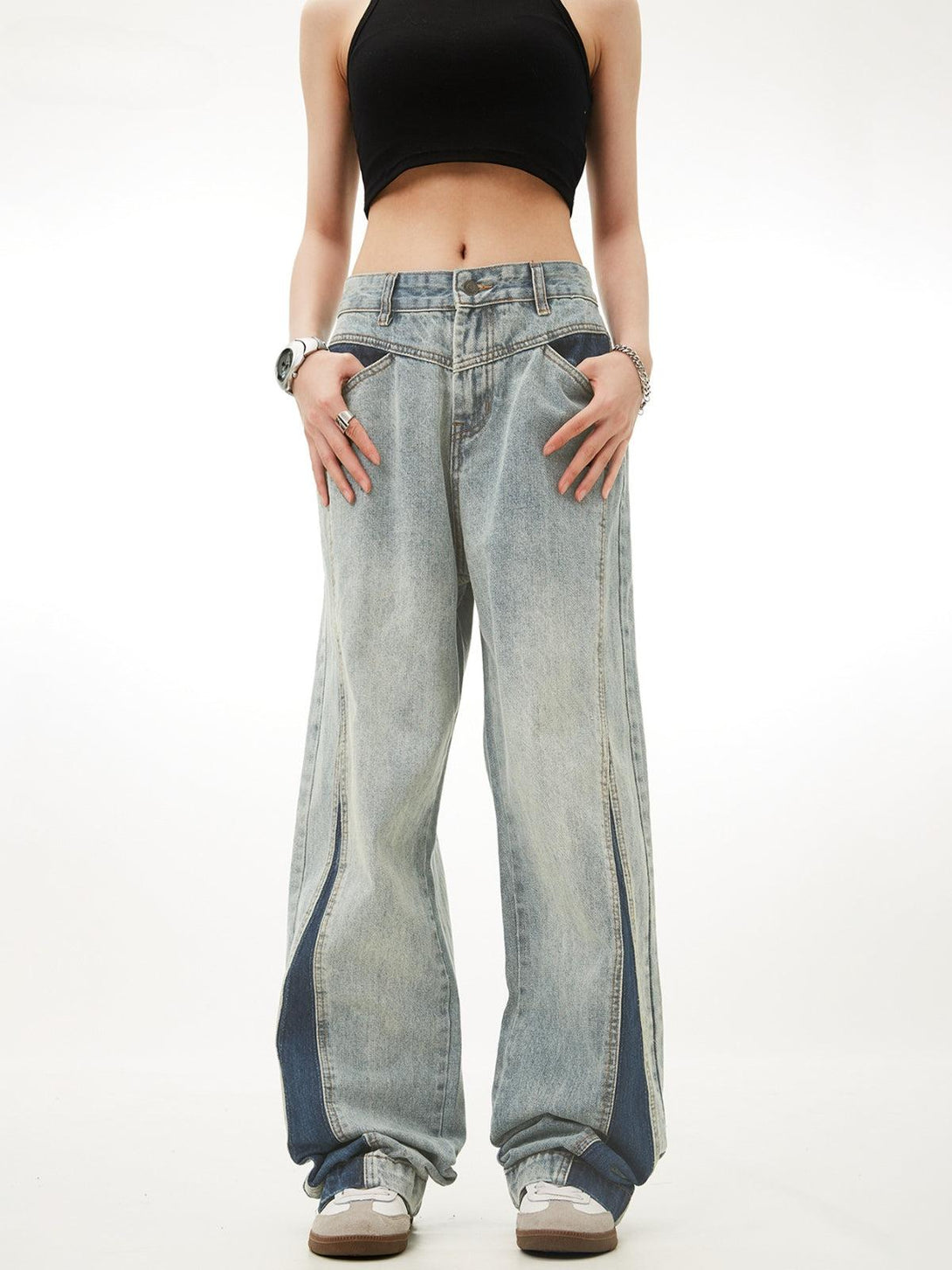 Model wearing TALISHKO patchwork color-blocking jeans, highlighting a relaxed, trendy fit.