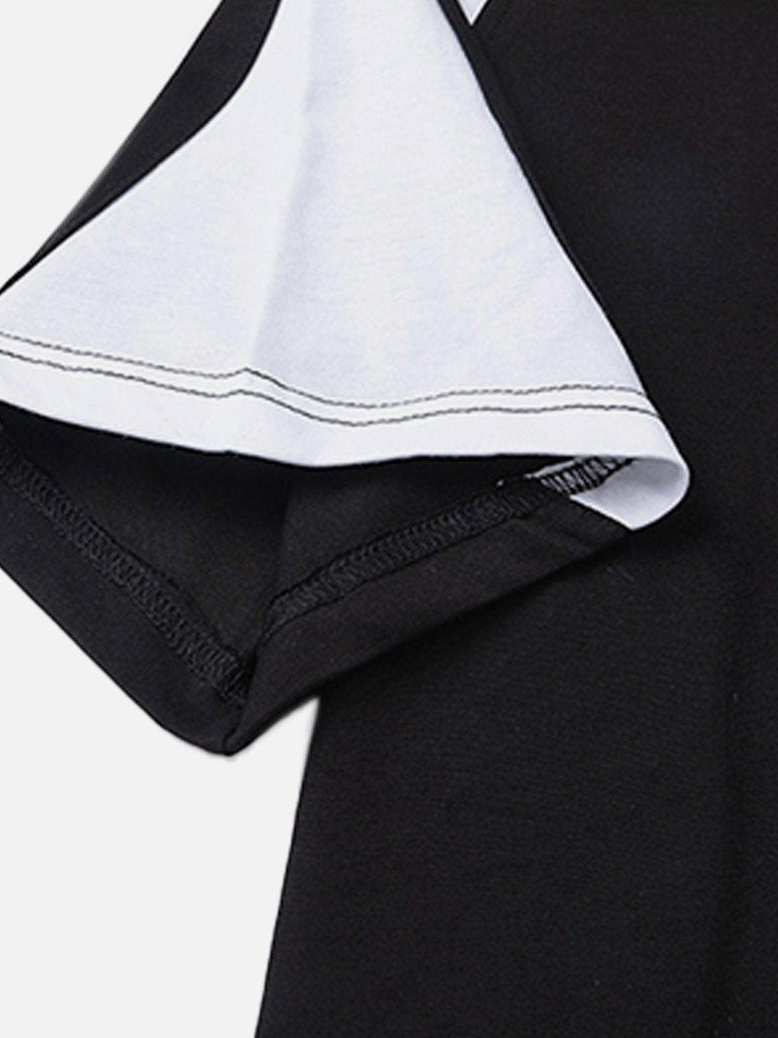 Intricate look at TALISHKO's patchwork tee, emphasizing detailed stitching and color contrast.