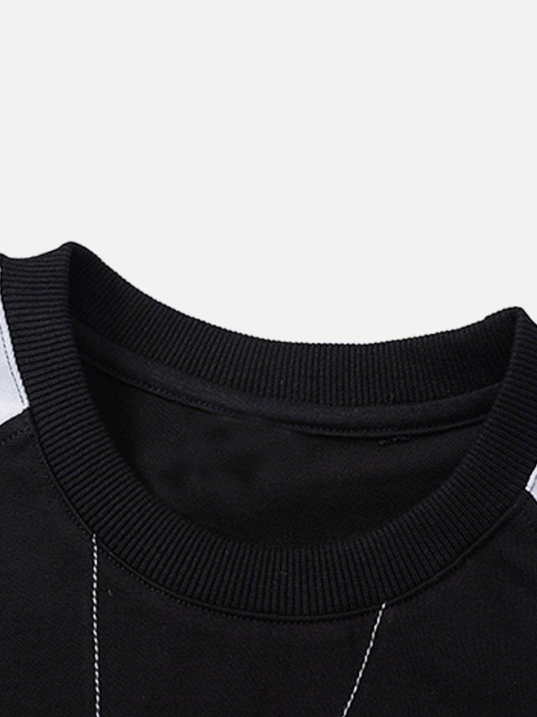 TALISHKO's patchwork tee neckline, focusing on ribbed texture and color contrast detail.