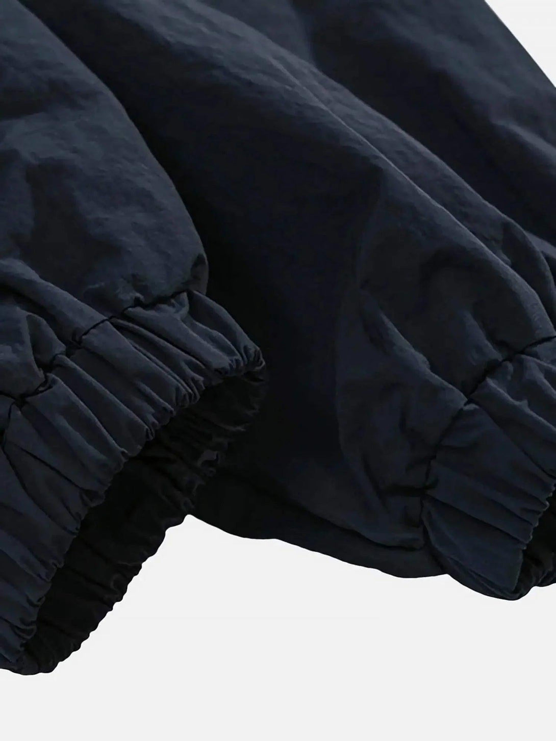 A close-up of TALISHKO windbreaker jacket sleeves showcasing elastic cuffs and textured fabric.