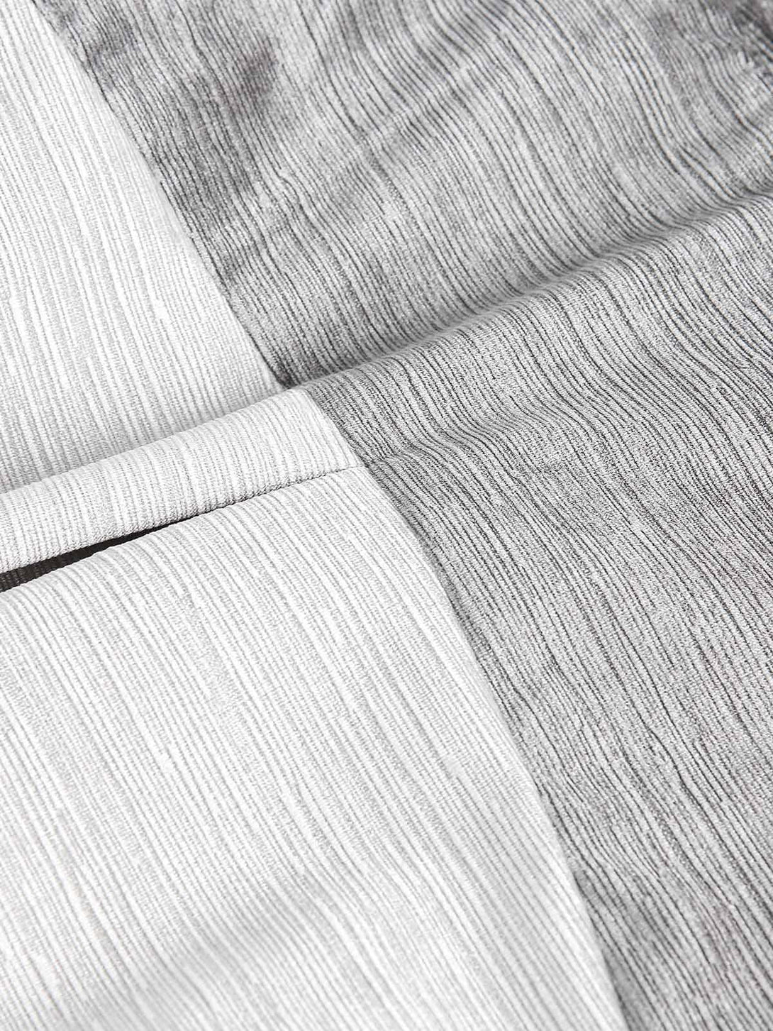 Intricate look at the patchwork texture of a bomber jacket by TALISHKO, highlighting unique design.