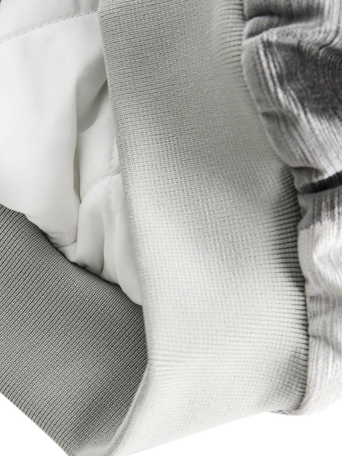 Detailed fabric and stitching inside TALISHKO bomber jacket, highlighting quality craftsmanship.