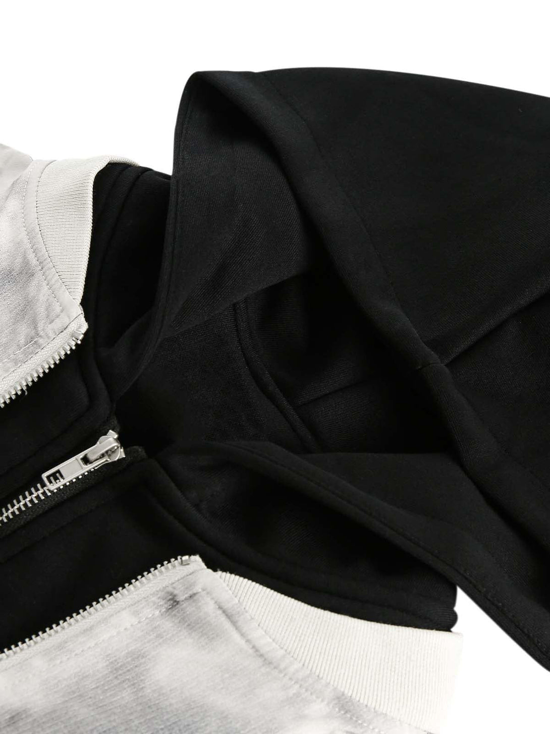 A detailed view of the TALISHKO bomber jacket's hood and zipper, showcasing its faux two-piece style.