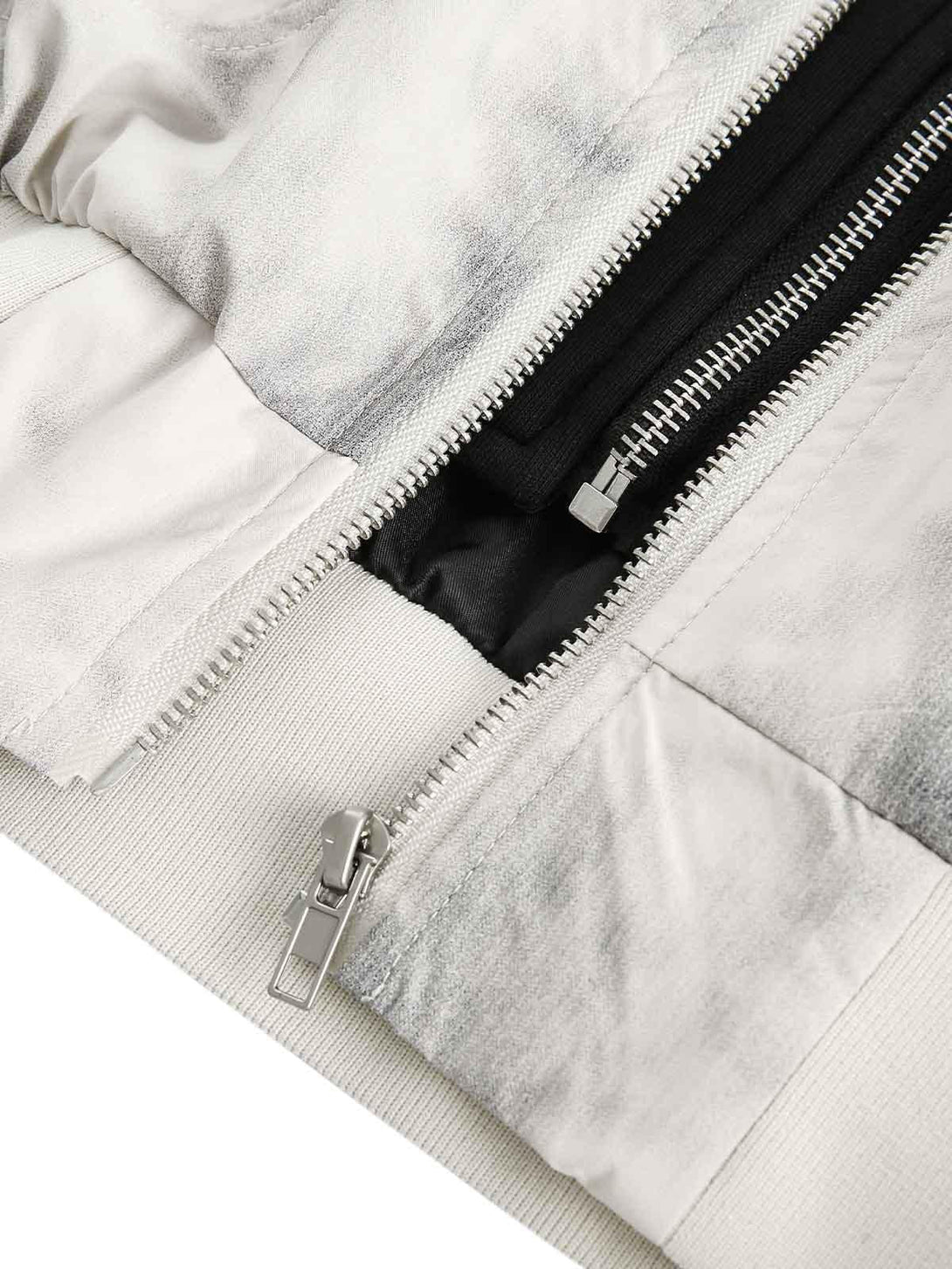 A tight crop highlighting TALISHKO's faux two-piece bomber jacket zipper and fabric details.