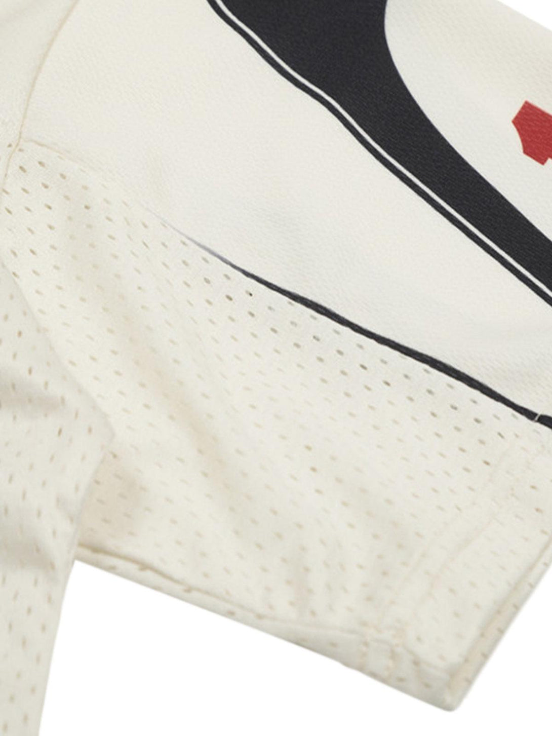 Detailed view of TALISHKO patchwork mesh jersey T-shirt sleeve, showcasing texture and design.