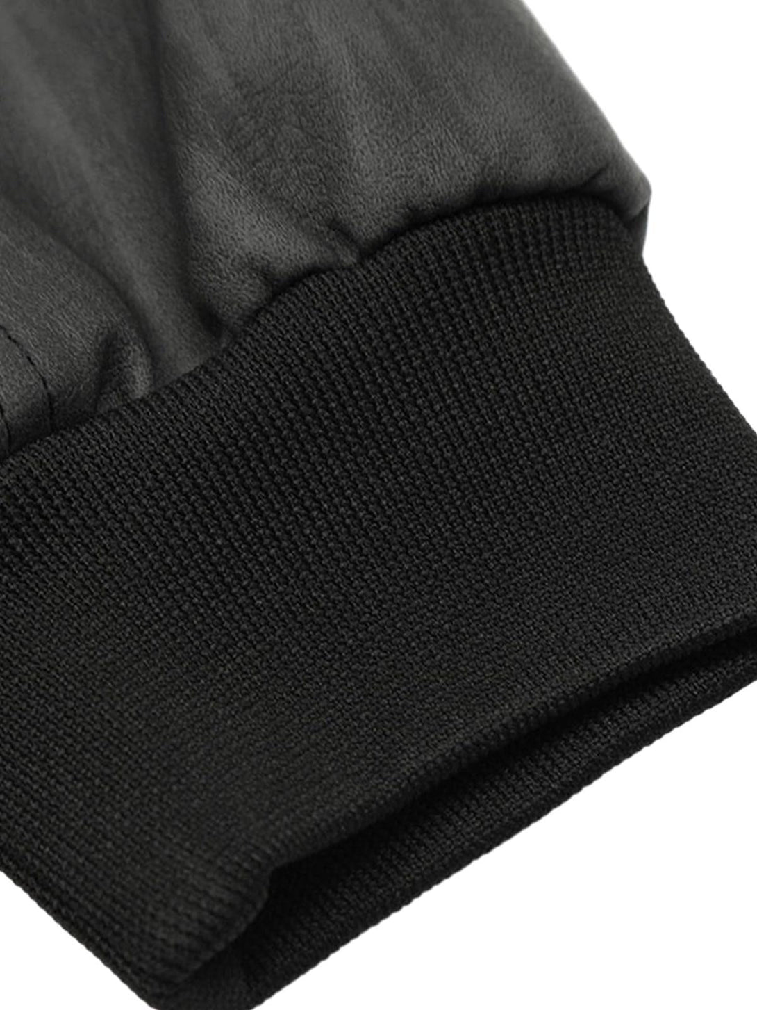 Tight crop highlighting the cuff detail of the TALISHKO patchwork hooded jacket.