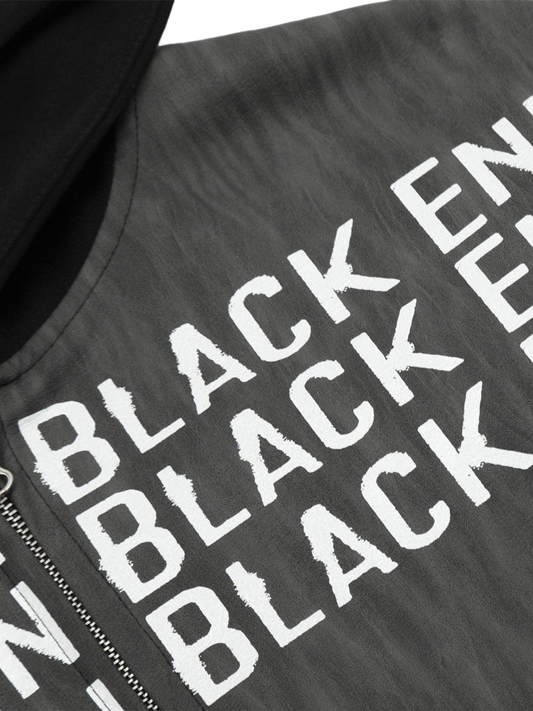 Detailed fabric and text design on the TALISHKO patchwork print zip-up hooded jacket.