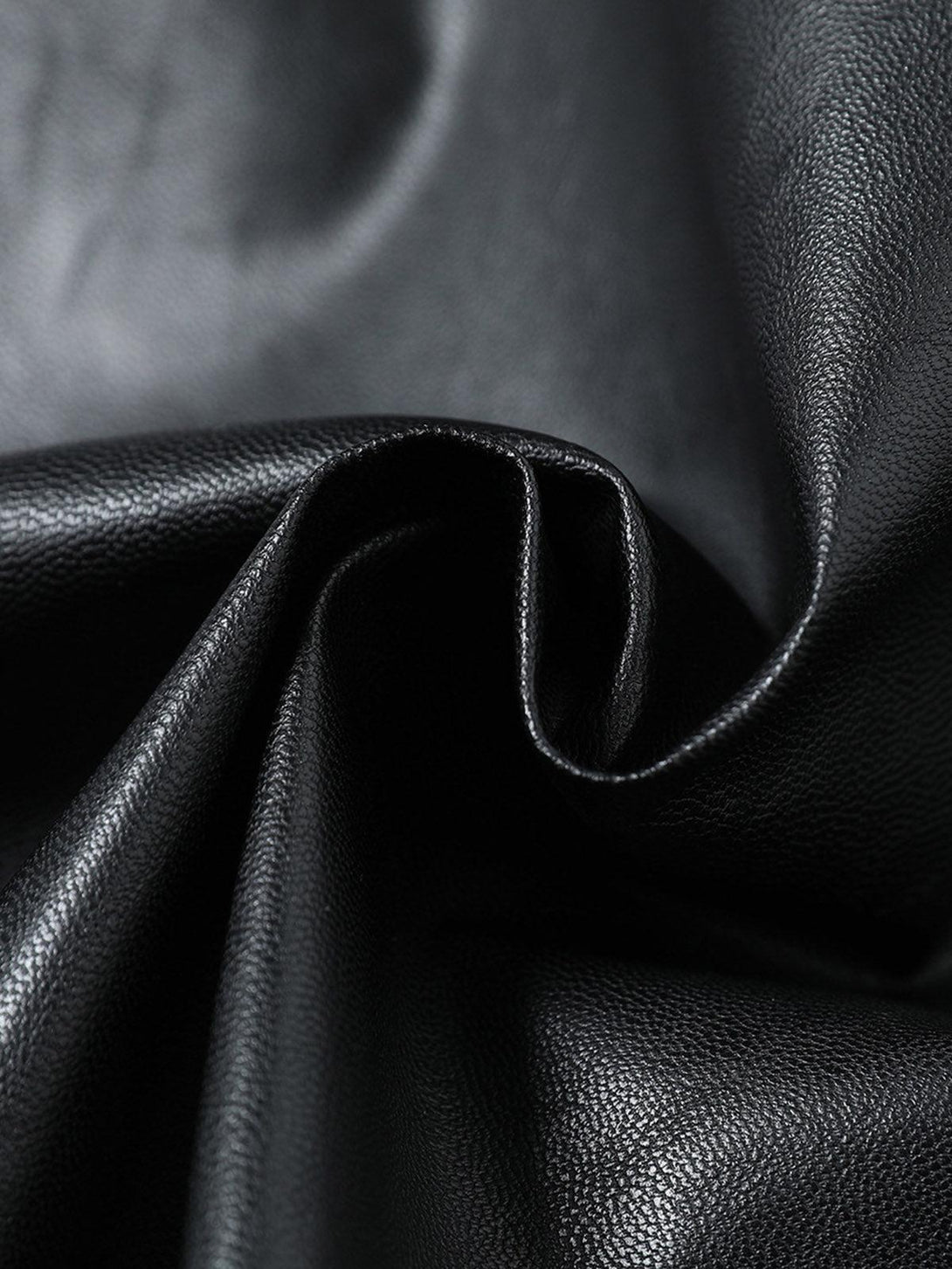 Zoomed-in view of TALISHKO's PU leather motorcycle jacket, showcasing its supple texture.