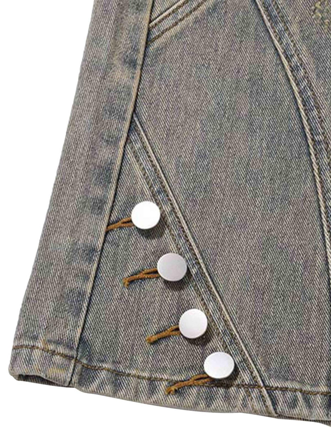 Detailed fabric and stitching on TALISHKO patchwork jeans, highlighting button accents.