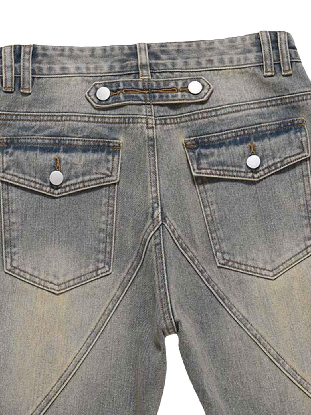 Back view of TALISHKO patchwork jeans highlighting unique stitching and buttoned pockets.