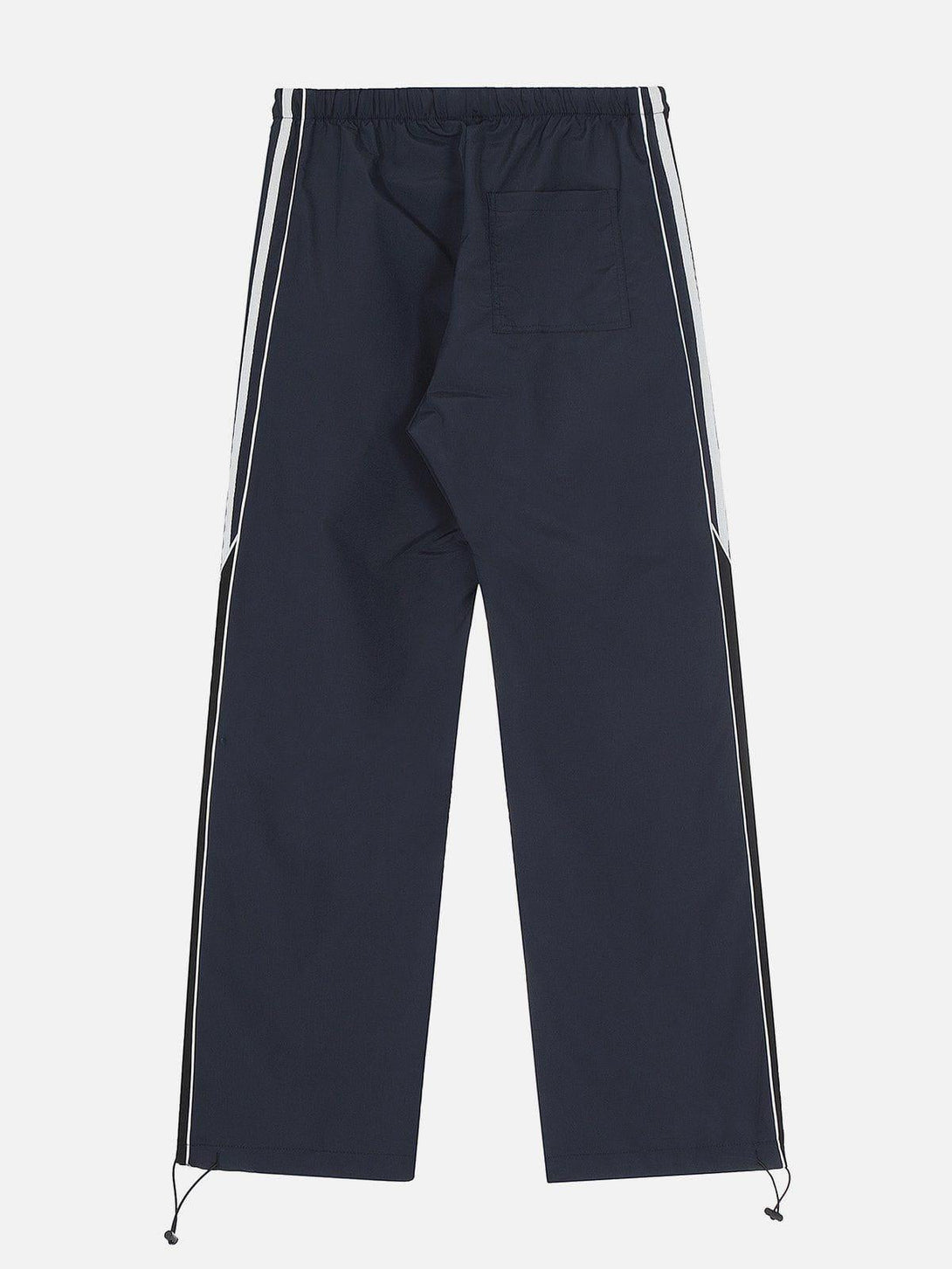Back view of TALISHKO's blue patchwork sweatpants, featuring sporty white side stripes.