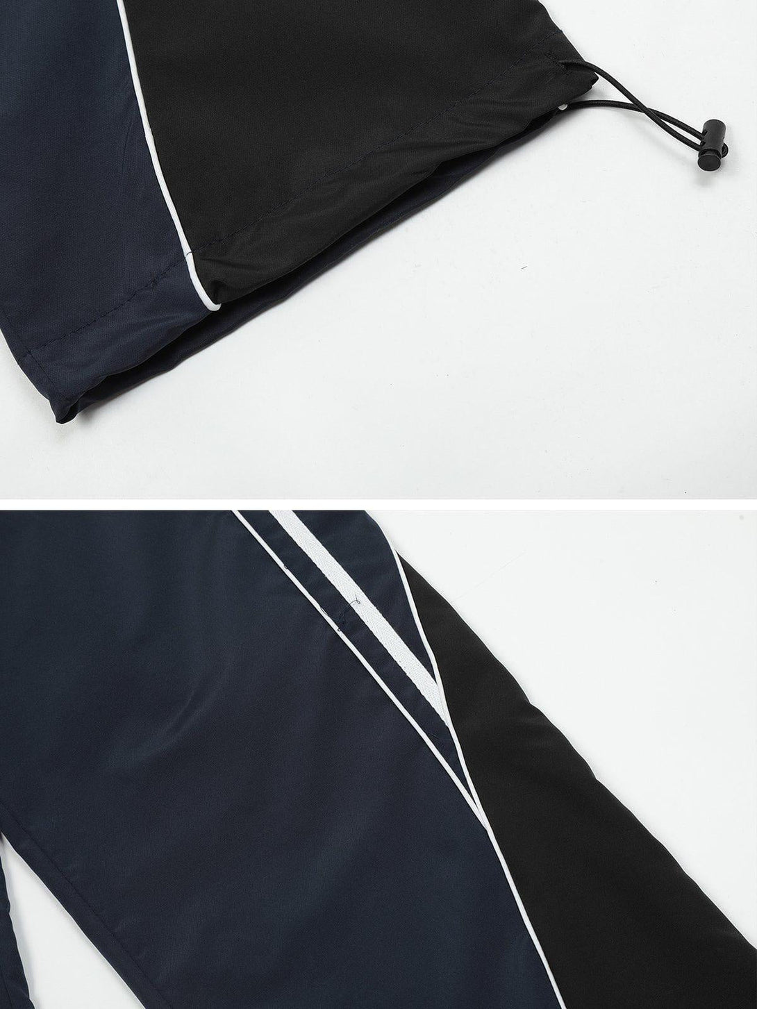 Detailed look at TALISHKO's sweatpants, highlighting sleek white stripes and drawstring detail.