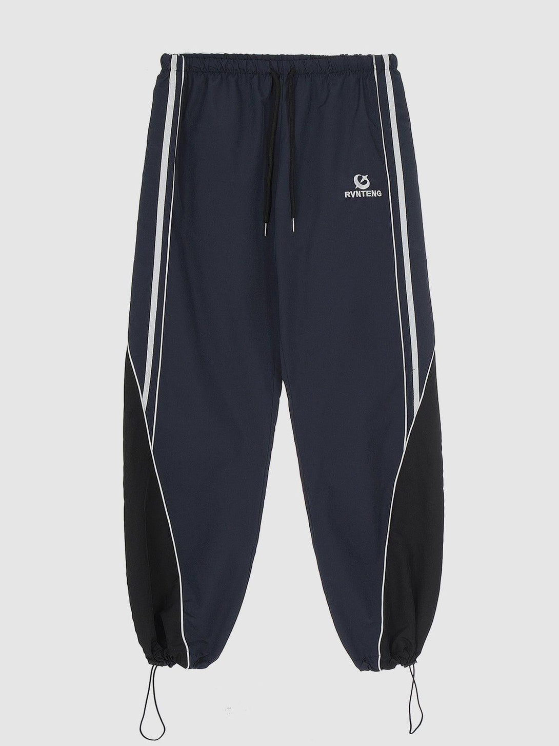 TALISHKO sweatpants in blue with sporty white stripes, showcasing a tapered leg design.