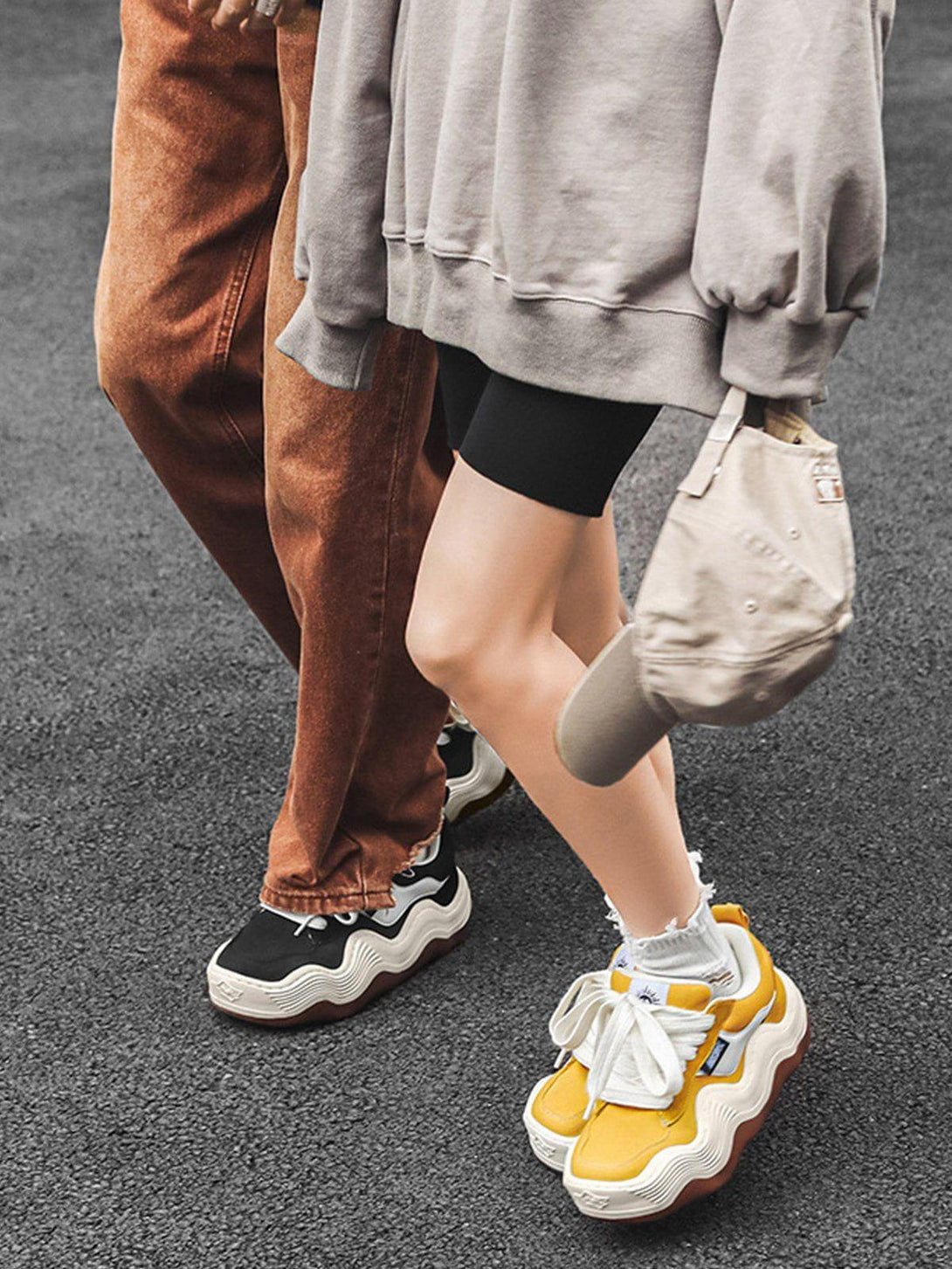 Casual streetwear look with TALISHKO sneakers, featuring thick wavy soles in black and yellow.