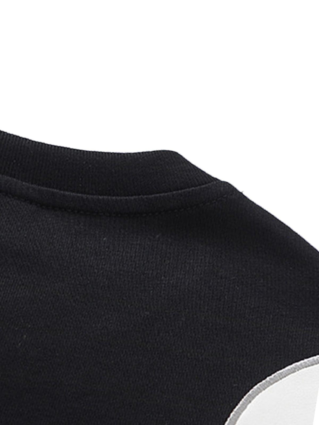 A detailed view of the TALISHKO Patchwork Totem T-shirt, showcasing its black and white design.