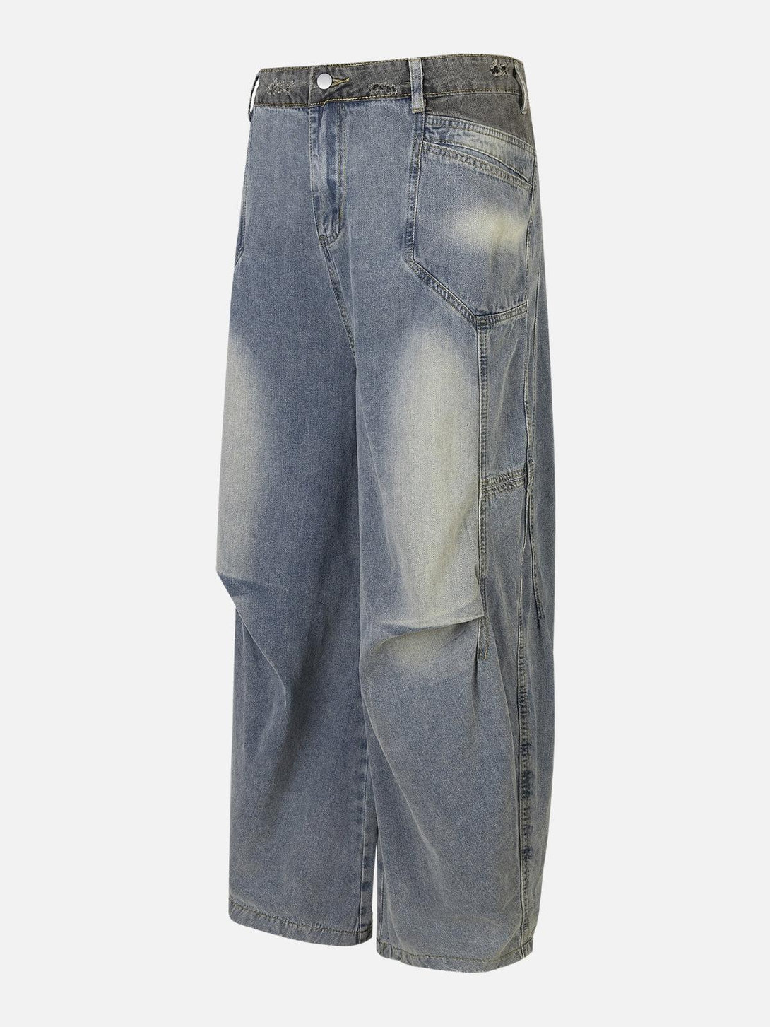 Side view of TALISHKO's loose jeans, featuring a patchwork waist and faded denim finish.