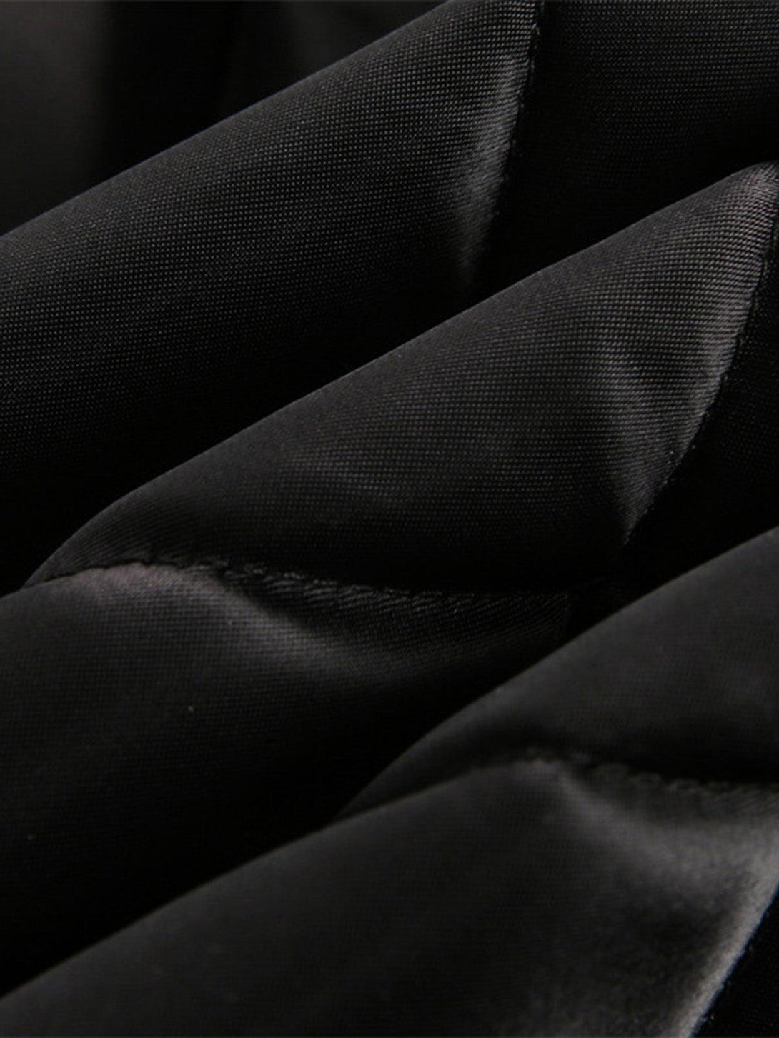 Texture and pattern showcased in TALISHKO's black diamond quilted jacket, highlighting sleek fabric.