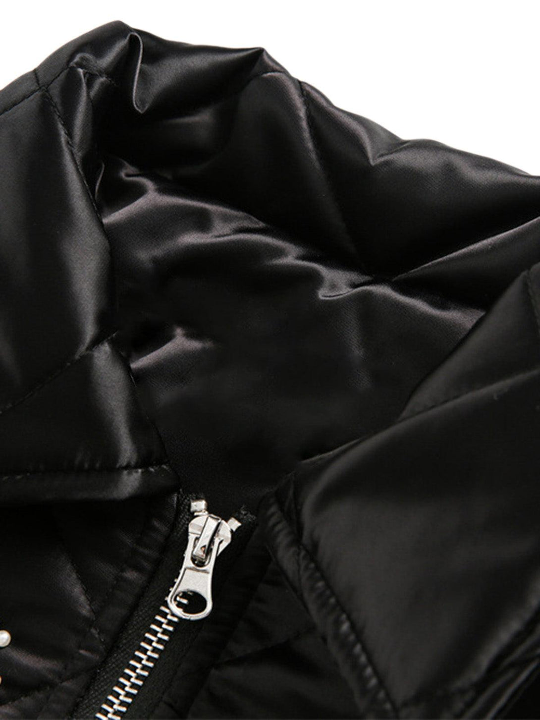 A close-up of TALISHKO's diamond quilted jacket collar, showcasing luxurious black fabric.