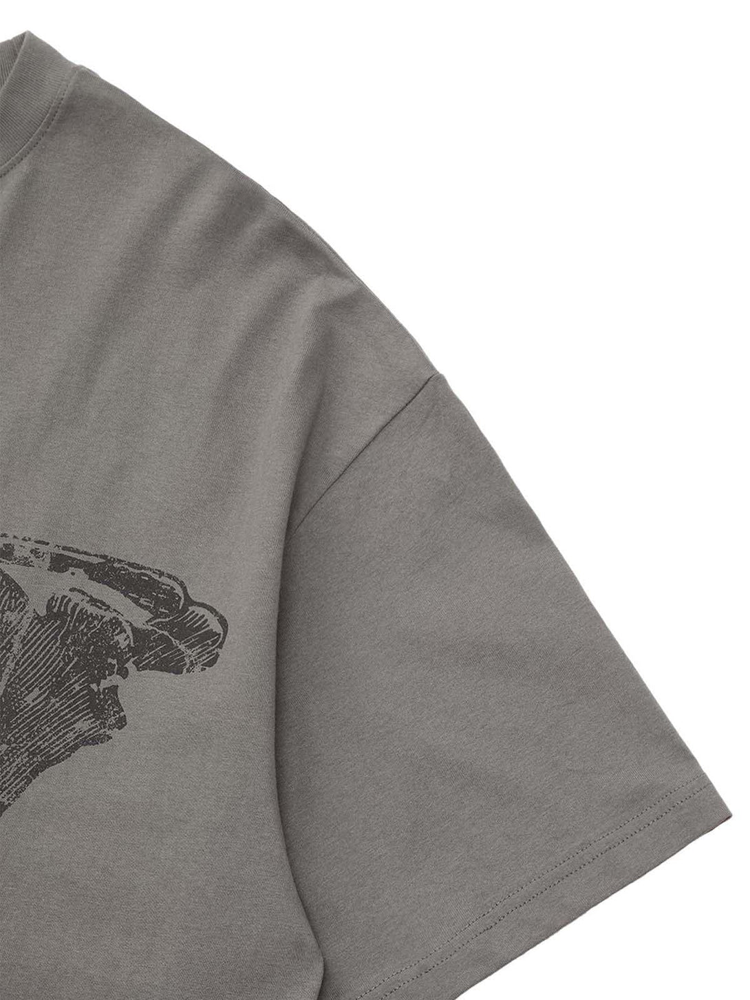 Intricate skull detail on a TALISHKO T-shirt sleeve, showcasing urban streetwear aesthetics.