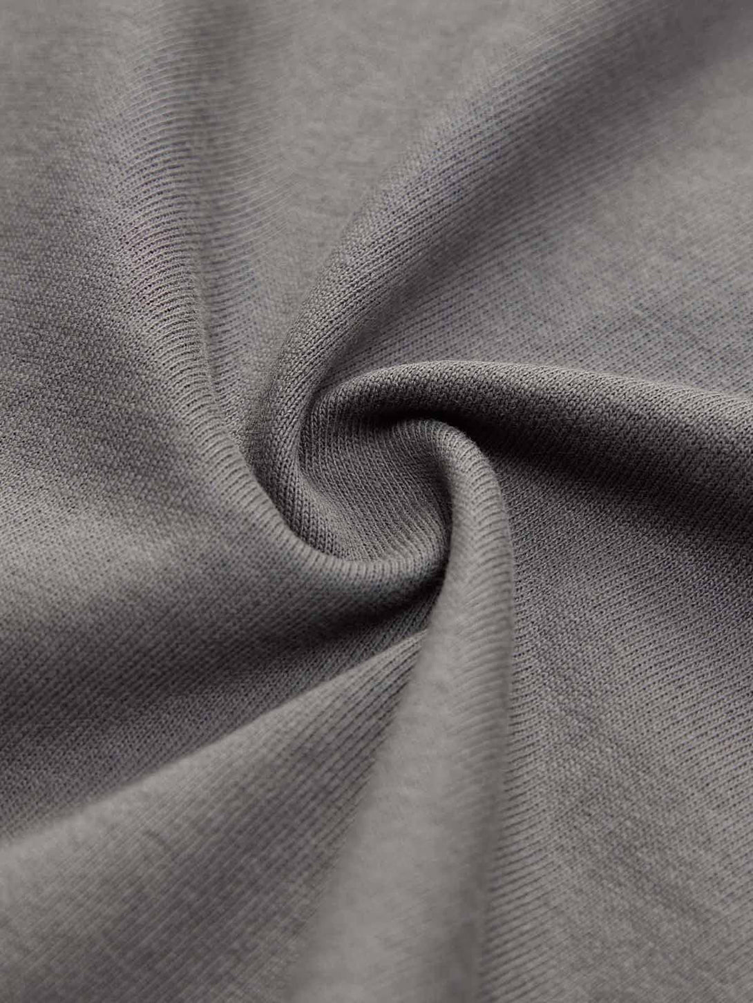 Zoomed-in texture of a TALISHKO T-shirt fabric, highlighting its soft and durable material.
