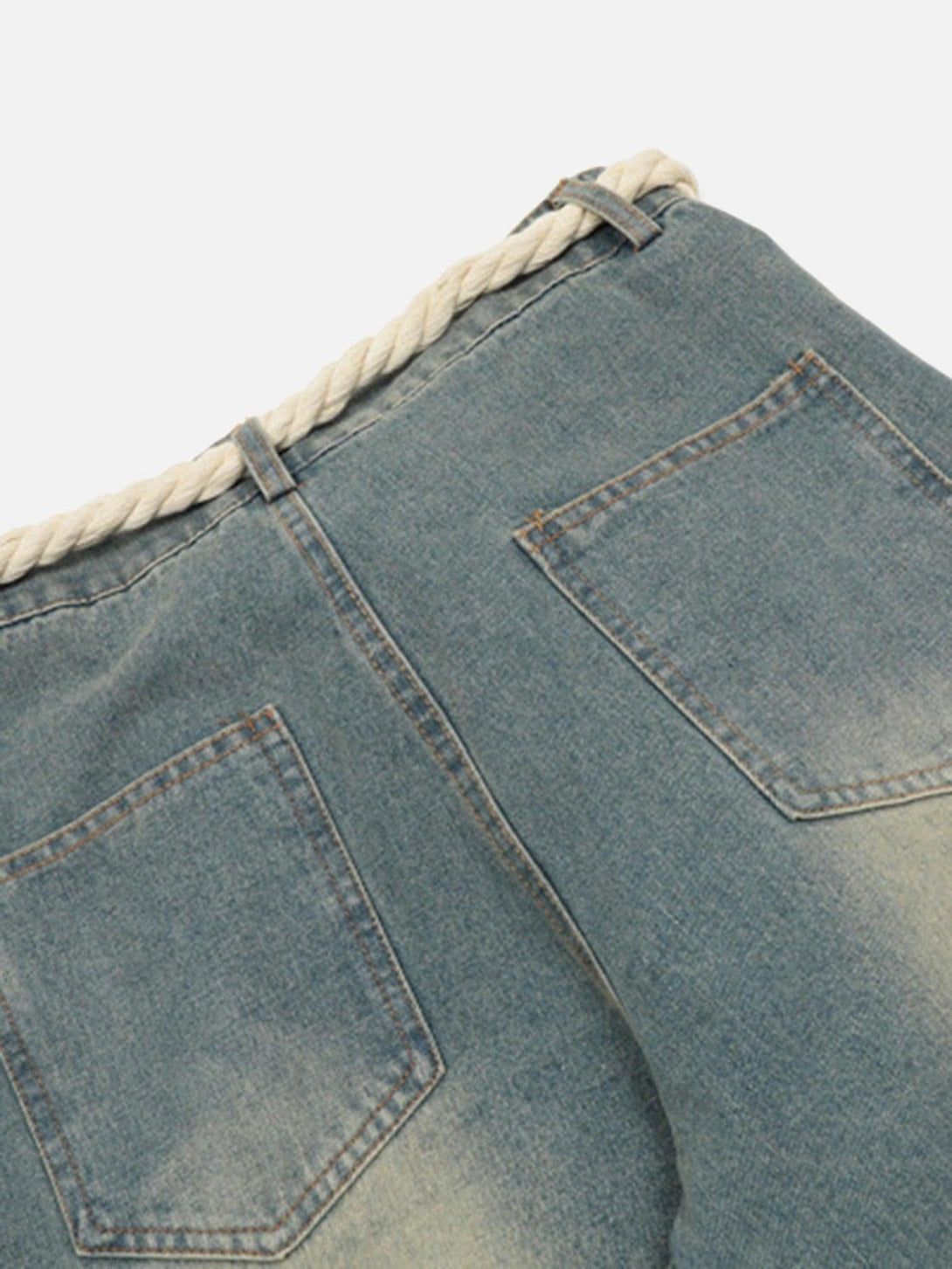 Back view of TALISHKO jeans, highlighting denim texture and unique rope belt detail.