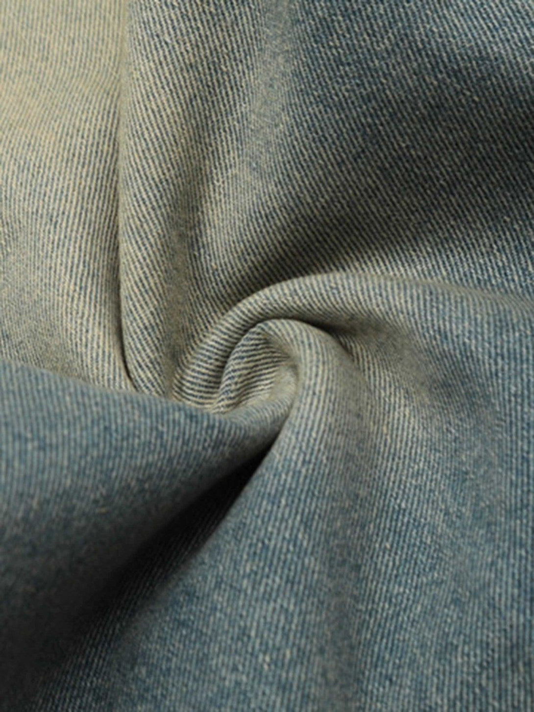Zoomed-in texture of TALISHKO loose jeans, highlighting the detailed denim weave.