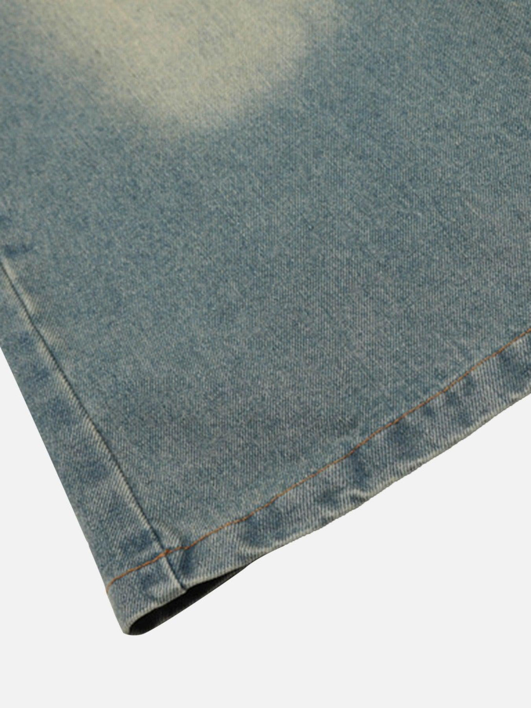 Detailed fabric and stitching of TALISHKO loose jeans with a focus on denim texture.