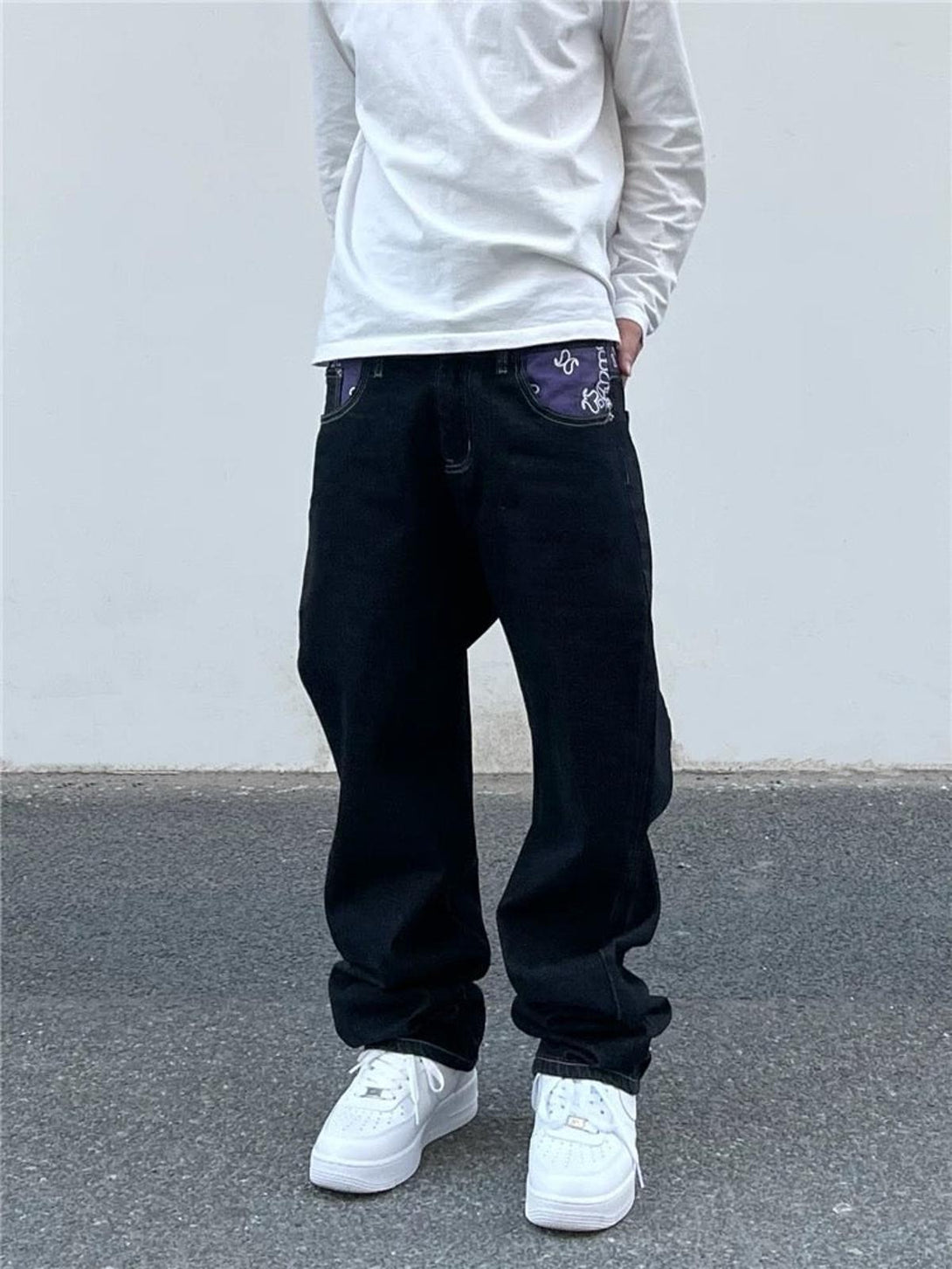 Model wearing TALISHKO straight jeans, highlighting purple pocket details with a relaxed fit.