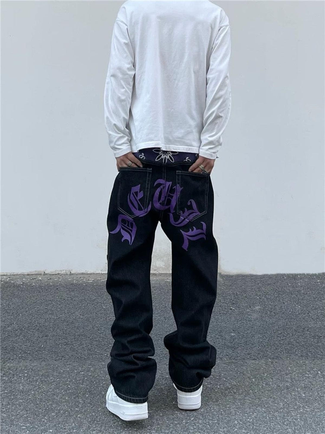 Back view of TALISHKO Petal Letter straight jeans with purple graphics and a relaxed fit.