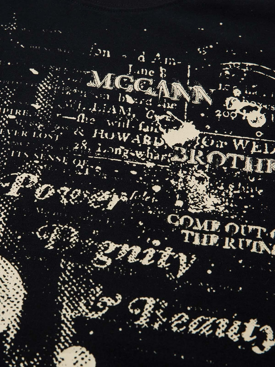 A tight crop highlighting the intricate letter print on the Phantom T-shirt by TALISHKO.