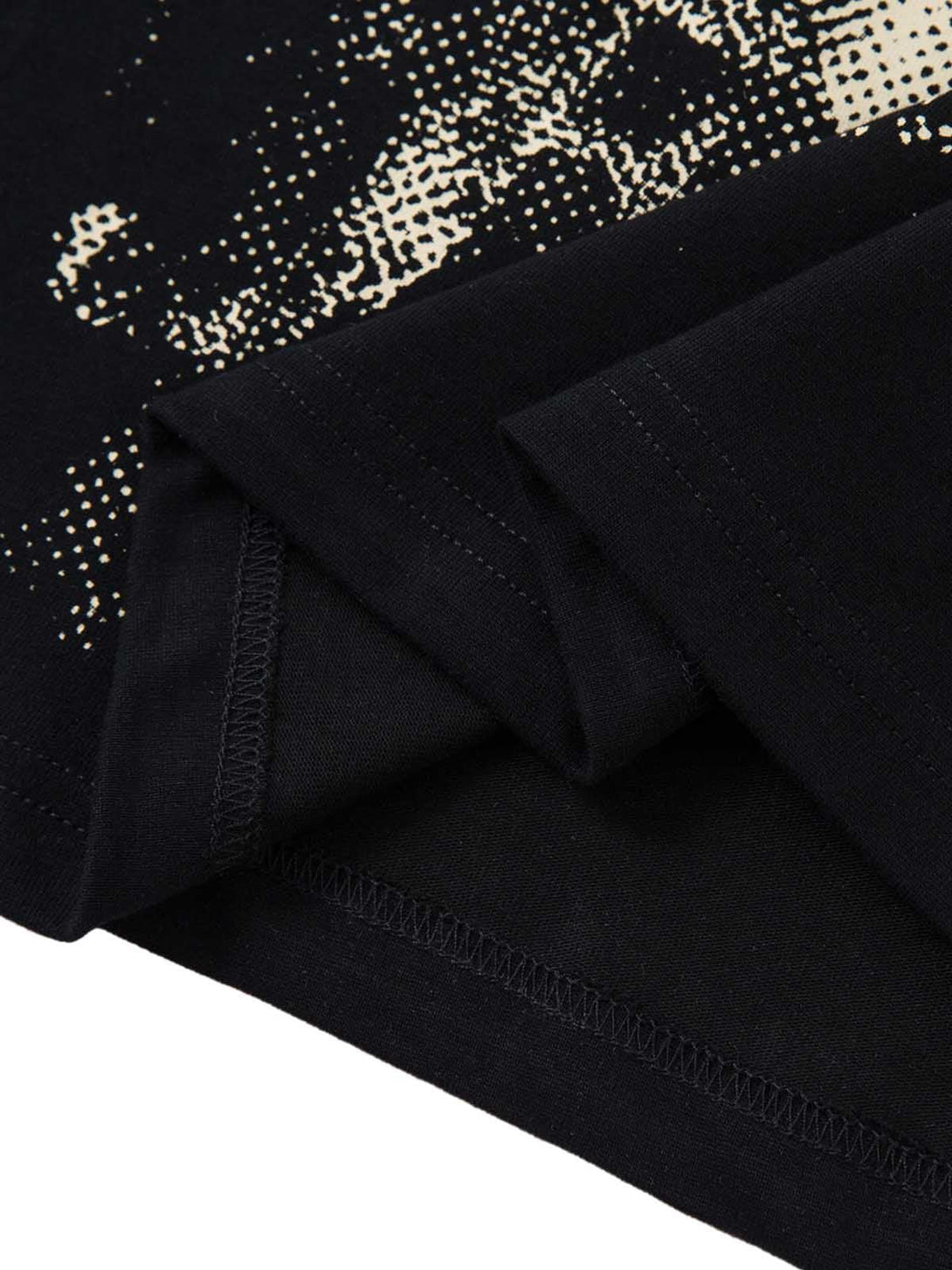 Detailed fabric and stitching of a black T-shirt by TALISHKO, featuring a unique print design.