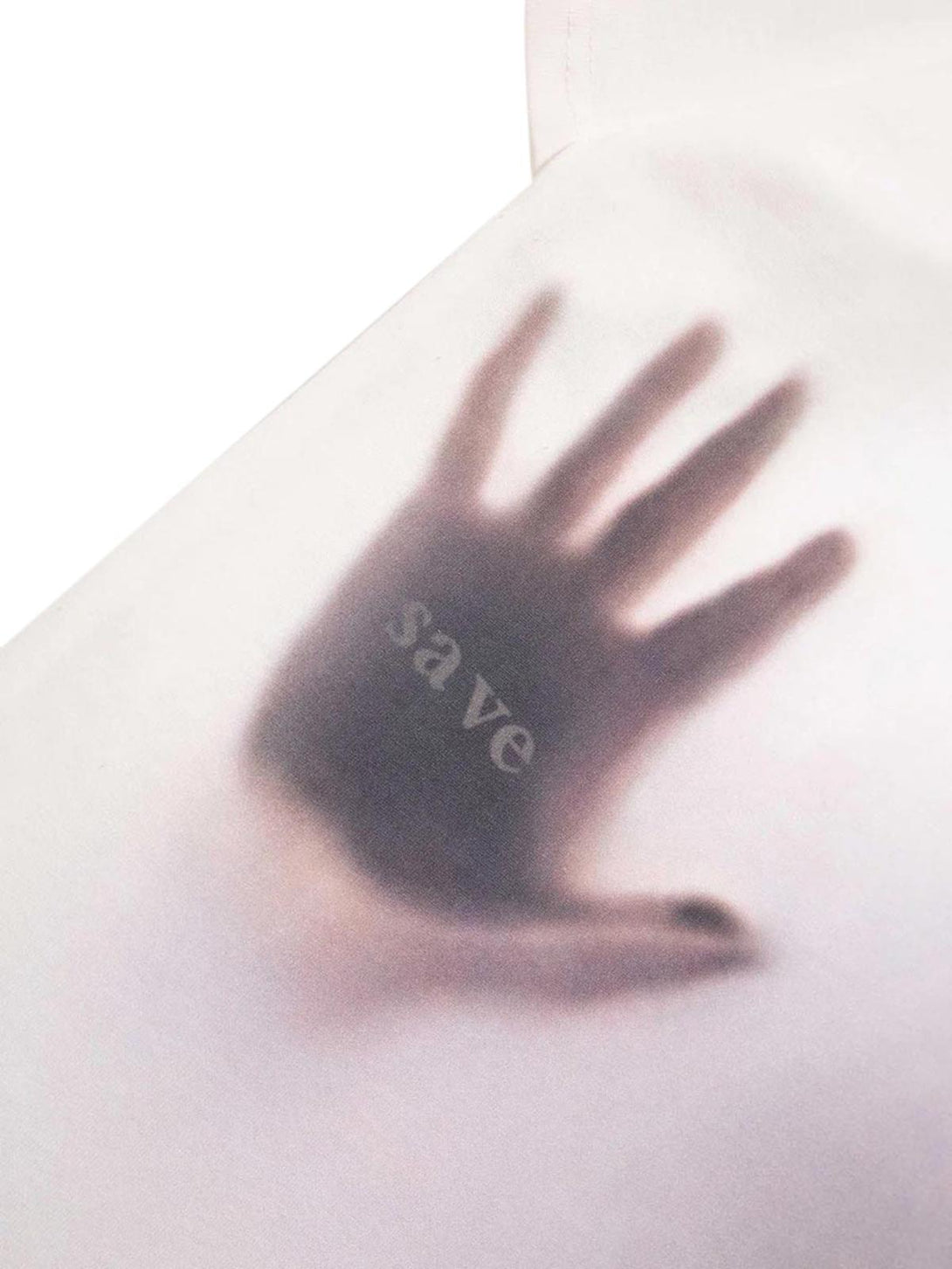Intricate look at the phantom handprint detail on a TALISHKO T-shirt, evoking a unique style.